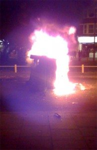A fire burning in the middle of a street.
